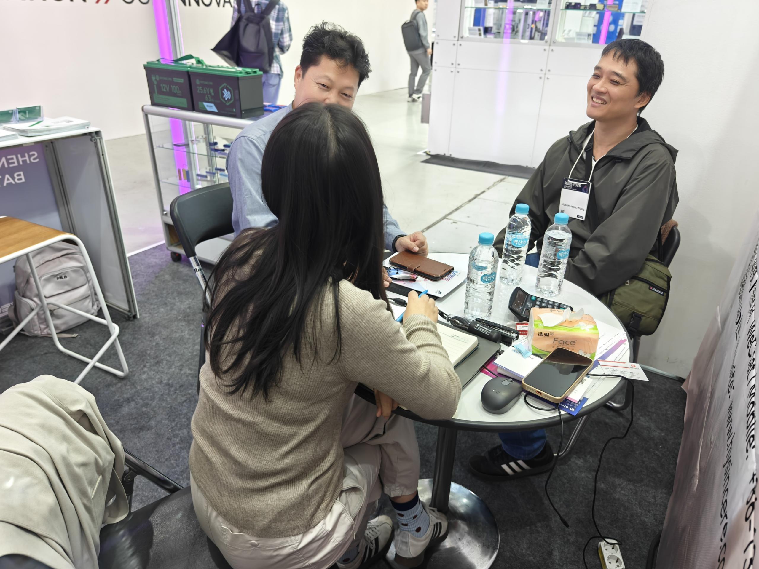 Hysincere team and visitors talking at a meeting table during KES 2026