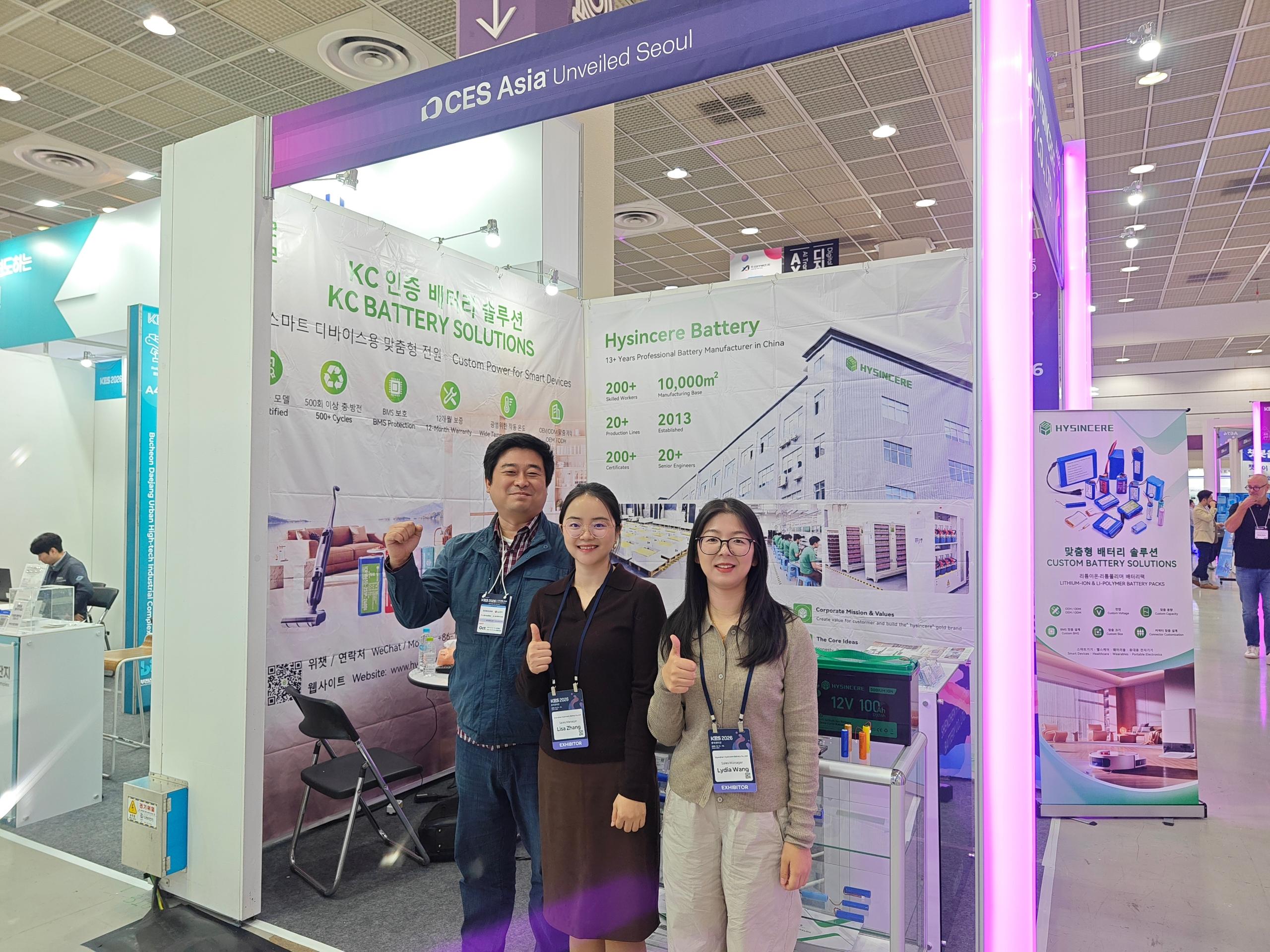 Three people posing at the Hysincere booth during KES 2026